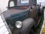 Rust-covered vintage Dodge pickup truck showing advanced exterior corrosion