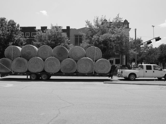 Ford F-350 diesel dually hauling hay on a road in Hillsboro, Texas